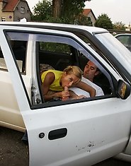 Hot MILF sucking two guys off on a parking lot